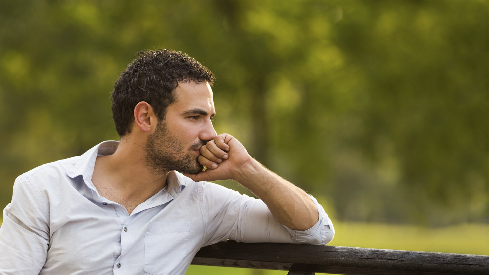 worried sceptical businessman sitting on a bench